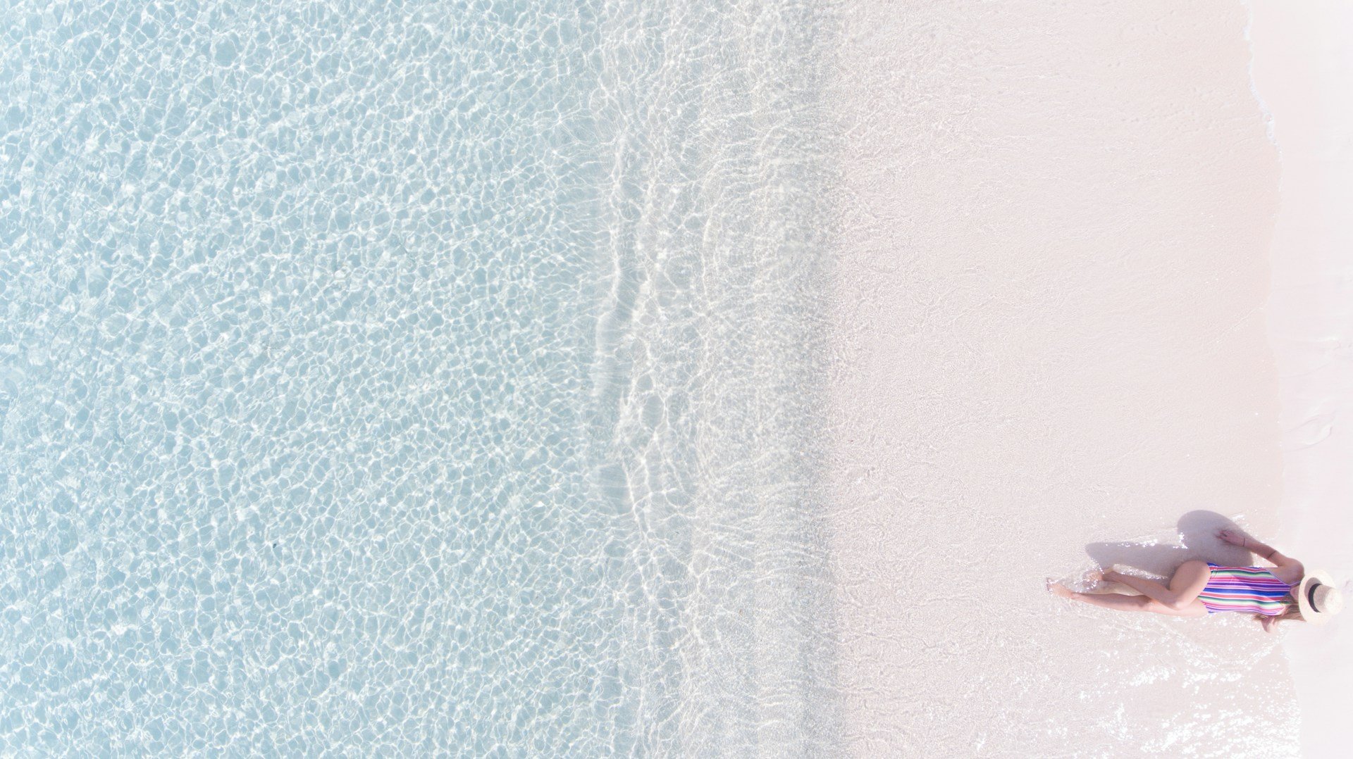 Aerial view of Seven Mile Beach in Grand Cayman with turquoise water and white sand