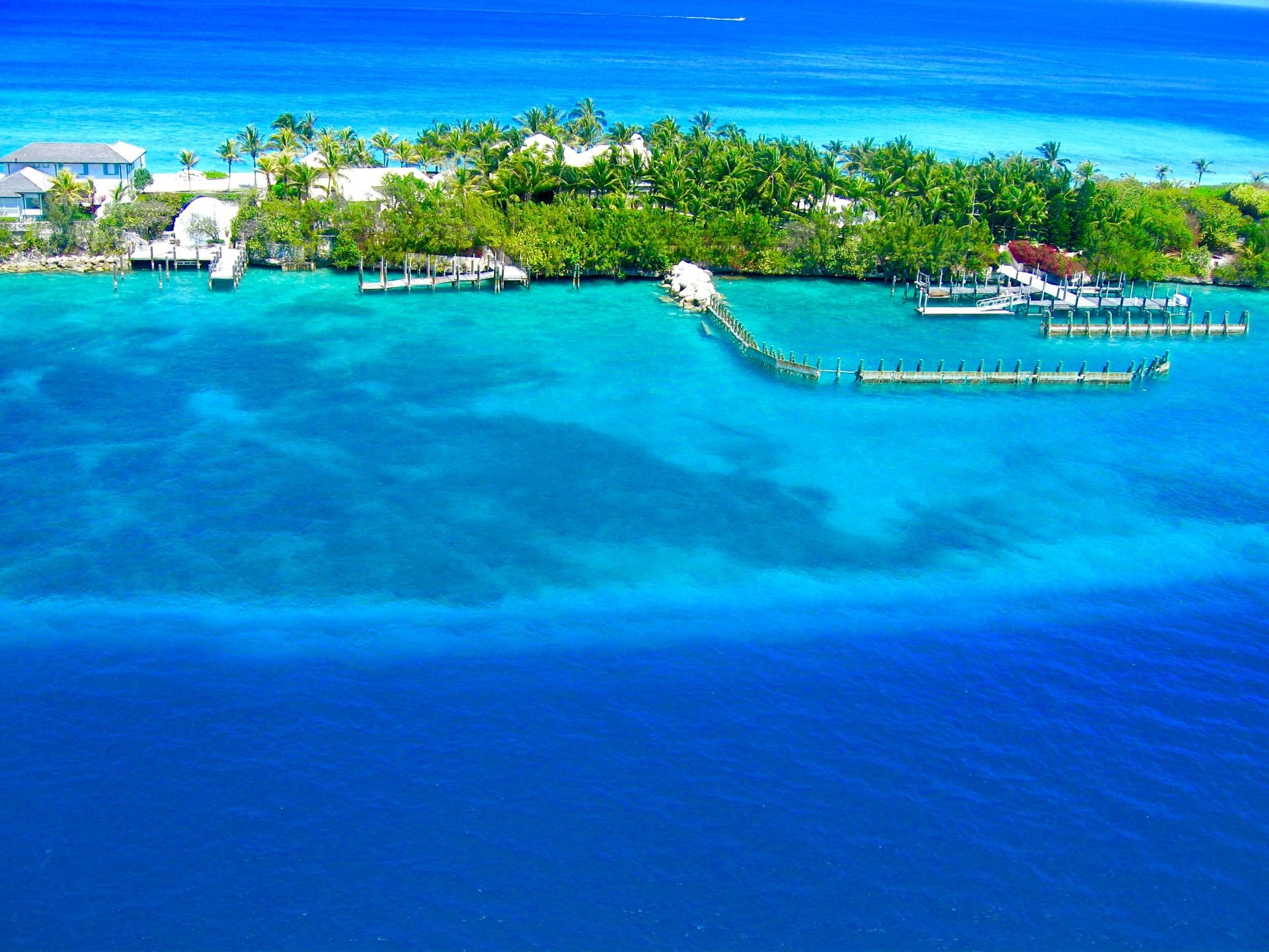 Aerial view of a palm-fringed island and turquoise water near Nassau, the Bahamas