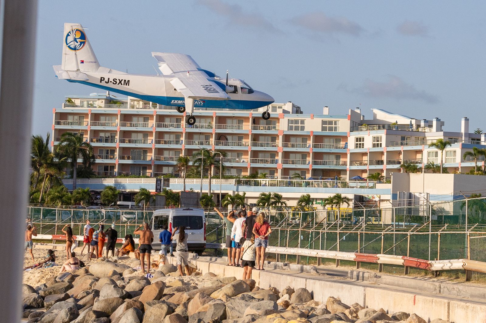 Aircraft flying low over Maho Beach beside a hotel, Sint Maarten