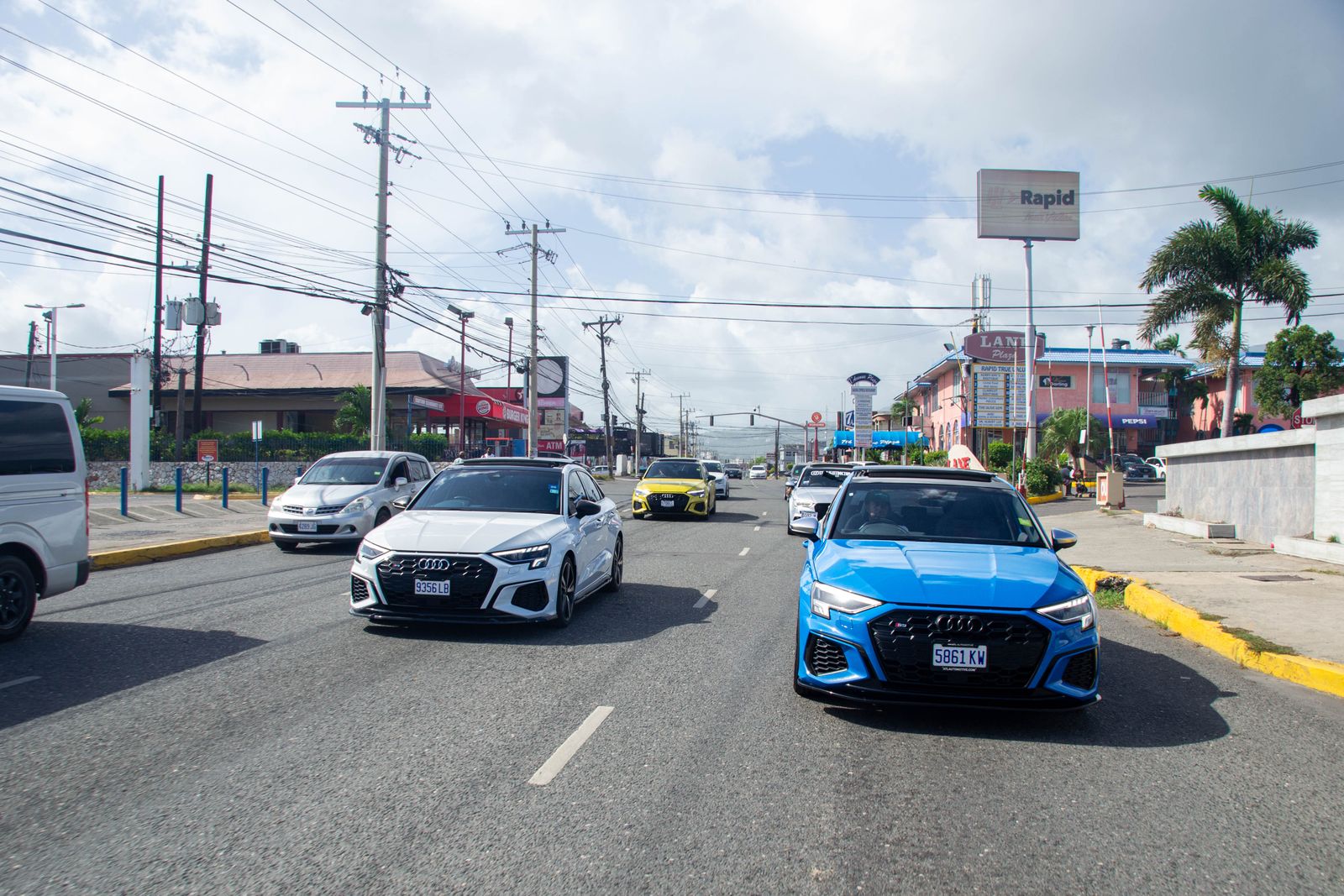 Busy street with shops and traffic in Jamaica