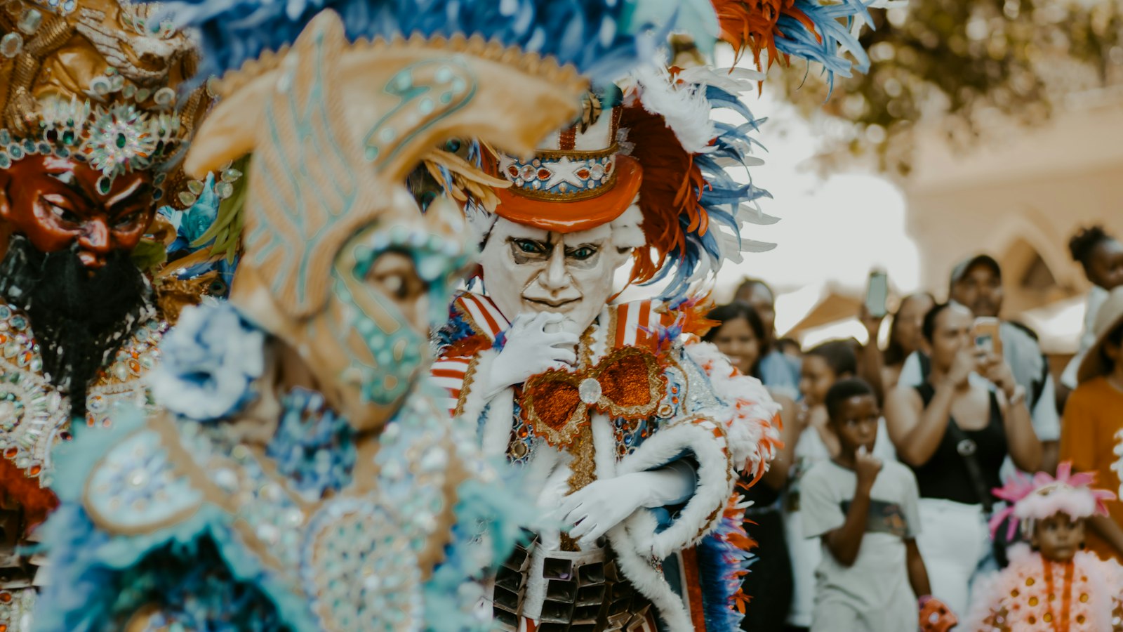 Masked carnival dancers in feathered costumes, Dominican Republic