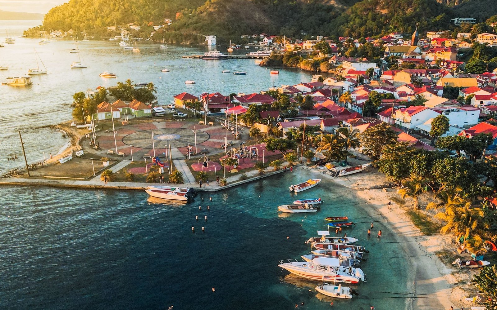 Aerial view of a bay with moored boats and seafront houses in Guadeloupe